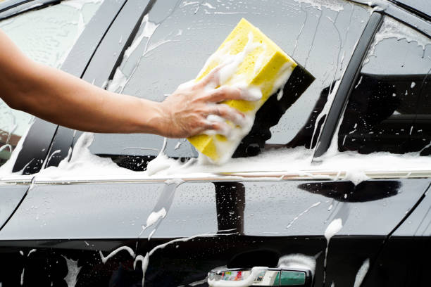 istock hands hold sponge for washing car. 1387482771