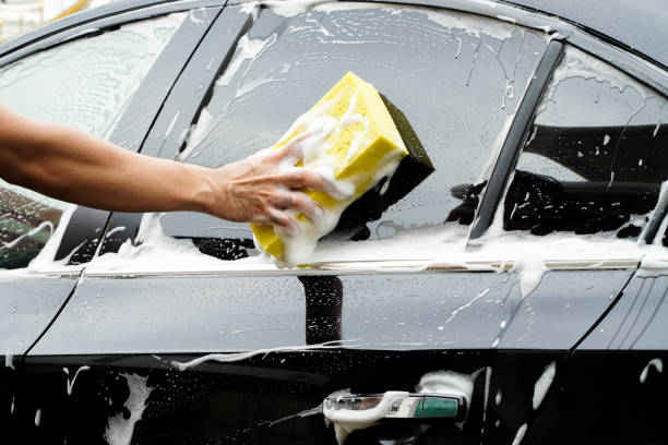 istock hands hold sponge for washing car. 1387482797