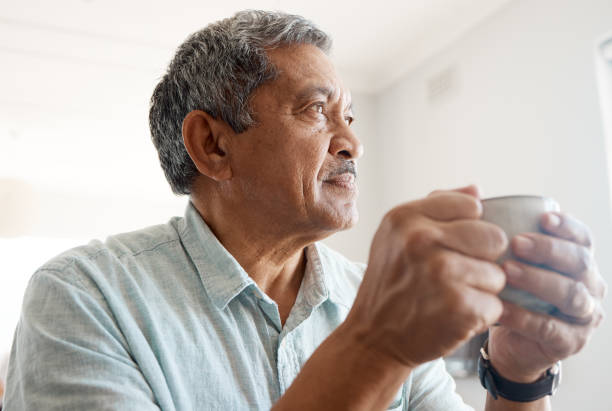 Shot of a senior man drinking coffee at home