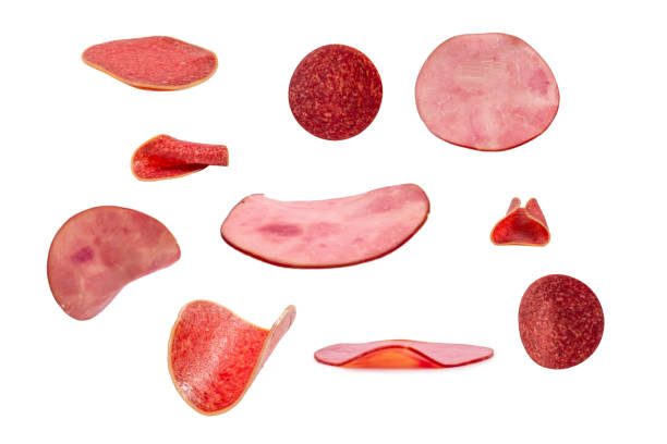 istock Falling tasty salami isolated on white background. 1387488436