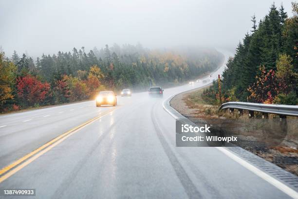 Car Point Of View Driving On Winding Wet Canadian Highway Stock Photo - Download Image Now