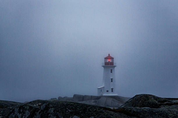 istock Peggy's Cove Lighthouse in Thick Evening Fog 1387490976