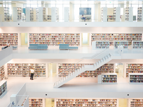 STUTTGART, GERMANY -12th OCTOBER 2018: White interior of a modern city library. The floors of books connected by a staircase. Stadtbibliothek, Stuttgart, Germany on October 2018.