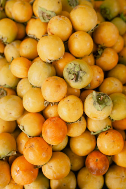 istock ripe persimmon lies on the counter, top view 1387492289