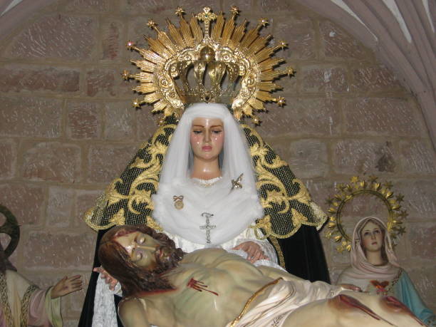 istock Virgin crying with Jesus Christ at her feet 1387493368
