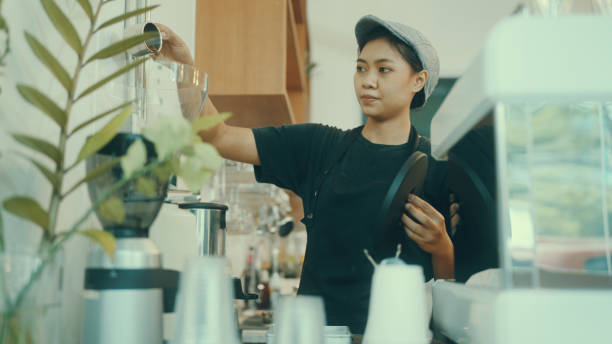 istock Employees make coffee in the shop for customers. 1387496500