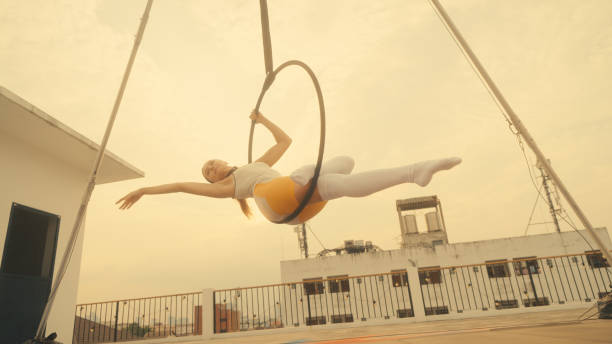 istock Female athlete practicing fly yoga poses 1387496704