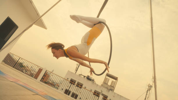 istock Female athlete practicing fly yoga poses 1387496725
