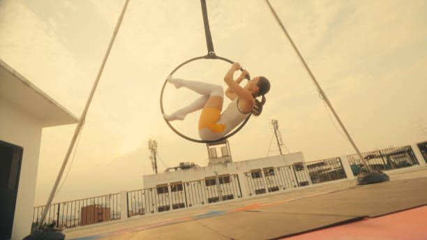 istock Female athlete practicing fly yoga poses 1387496736