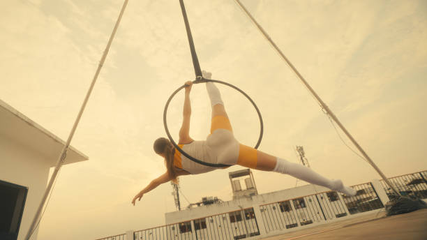 istock Female athlete practicing fly yoga poses 1387496833