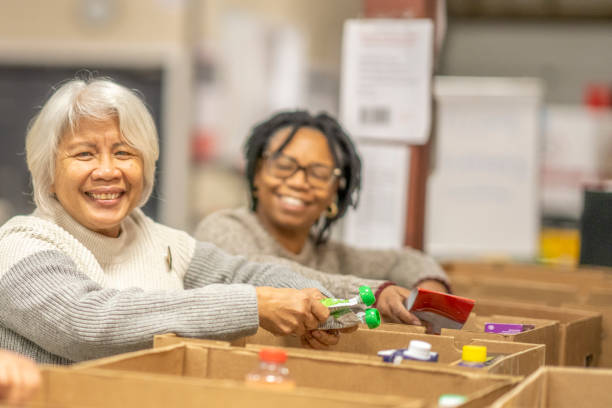 istock Seniors Packing Boxes at a Food Bank 1387498685