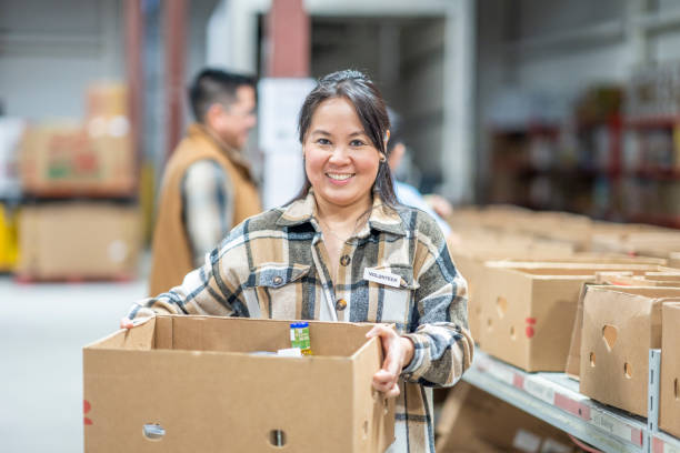 istock Asian Woman Volunteering Her Time 1387498690