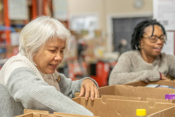 istock Seniors Packing Boxes at a Food Bank 1387498702