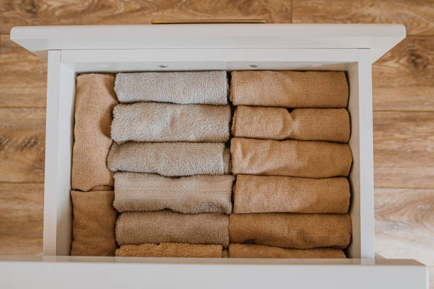 istock close up of an open drawer with folded towels. 1387501048