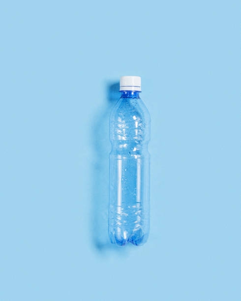 istock Blue plastic bottle on blue paper background, top view empty plastic bottle for water half litre, minimal style. Pollution, plastic garbage, environmental protection concept. 1387503267