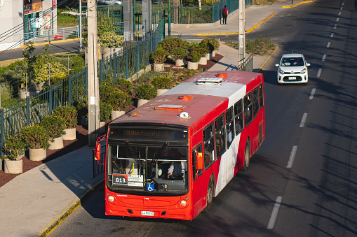 Santiago, Chile -  October 2021: A Transantiago, or Red Metropolitana de Movilidad,  public transport bus in downtown Santiago during a week day. This bus is part of the Transantiago public transport system, which covers Santiago and includes the Subway since 2007