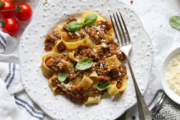 istock Pappardelle pasta with lentil ragout on light background. 1387503410