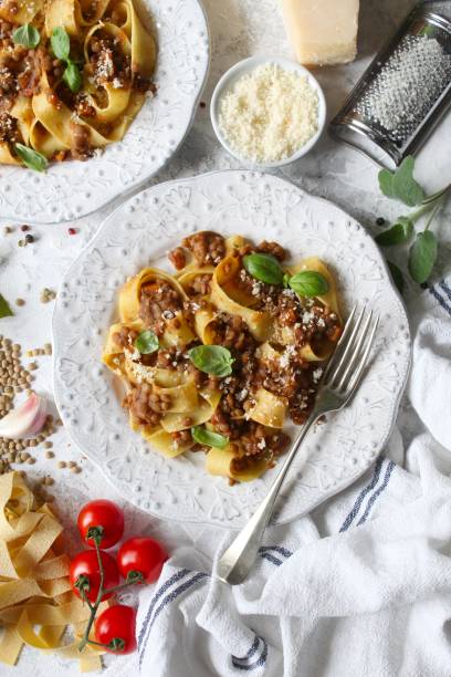 istock Pappardelle pasta with lentil ragout on light background. 1387503421