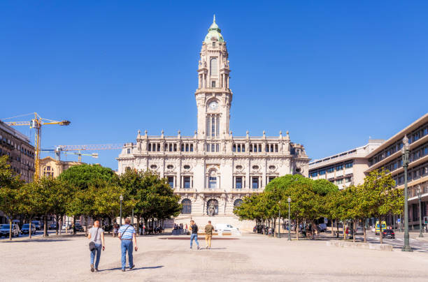 Porto, Portugal - Pedestrians walking towards the imposing facade of Porto's City Hall.