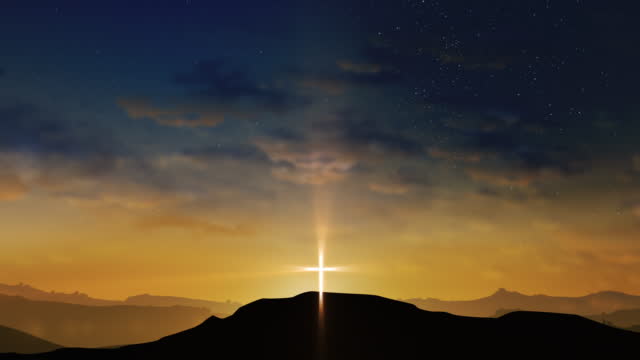 Bright cross on the hill with clouds moving on the starry sky