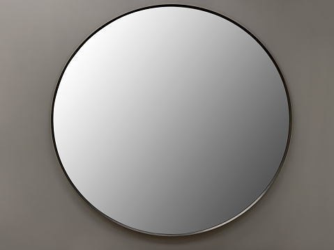 Front view circle shape mirror hanging on the wall (Frame with Clipping Path)