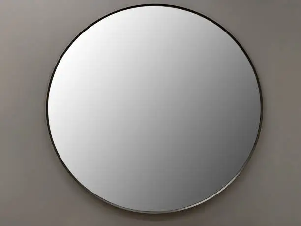 Front view circle shape mirror hanging on the wall (Frame with Clipping Path)