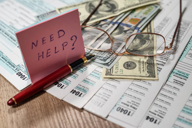 istock Financial document with dollar us 1040 tax form 1387510299