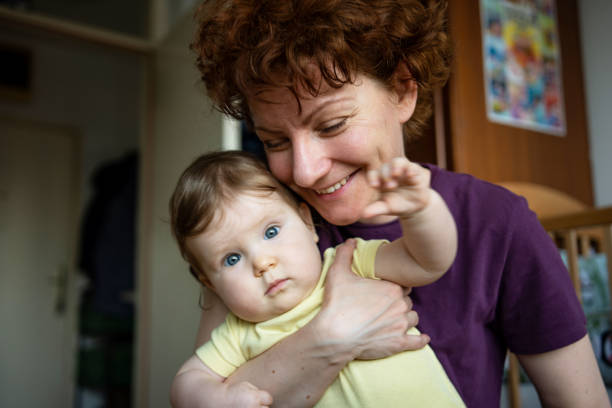 Mother enjoying with her baby daughter