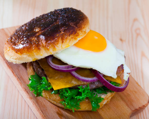istock Hamburger with fried egg, bacon, cheese, lettuce, onion 1387512490