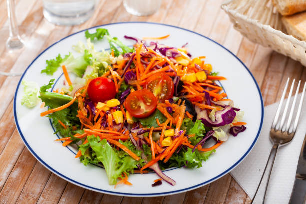 istock Fresh mixed salad with lettuce, corn, olives and cherry tomatoes 1387512502
