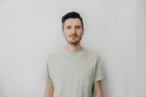 istock Handsome young man over grey wall with serious expression on face. Simple natural looking at camera 1387513086
