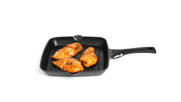 istock Chicken fillet on grill pan isolated on a white background 1387514171
