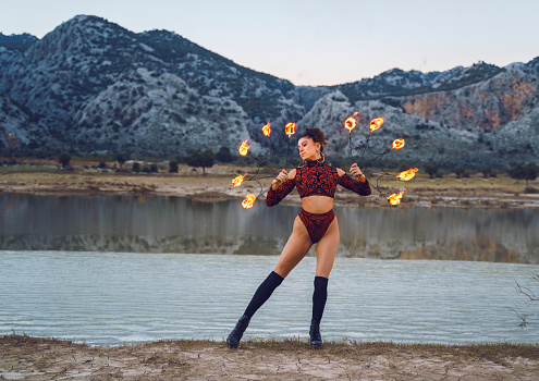 Woman doing fire performance dance in outdoor