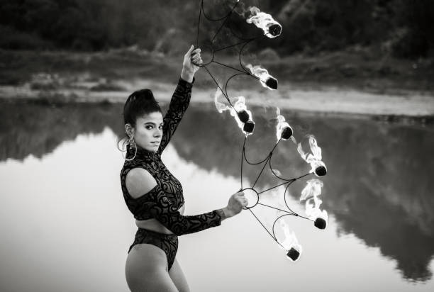 Woman doing fire performance dance in outdoor