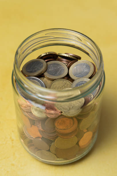 istock Glass jar with coins. Saving money concept 1387514274