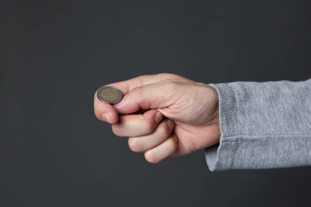 istock Hand ready to flip coin. Heads or tails game 1387514325