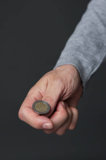 istock Hand ready to flip coin. Heads or tails game 1387514391