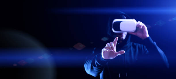 istock Vr goggles virtual reality. Young man in digital helmet for 3d virtual reality game on dark background. Study and virtual world in 3D simulation. 1387514402