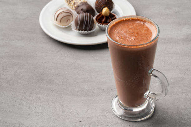 istock Coffee cup and sweet candy on gray table 1387515747