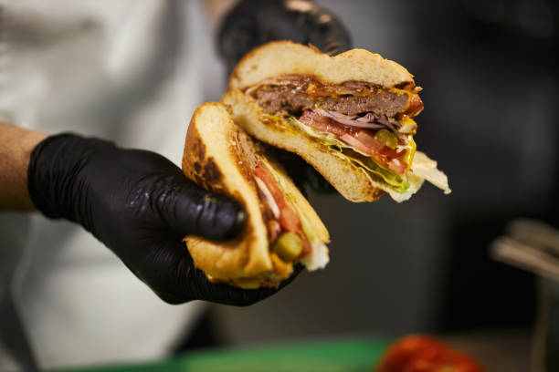 istock Male hands holding juicy grilled beef burger. 1387517721