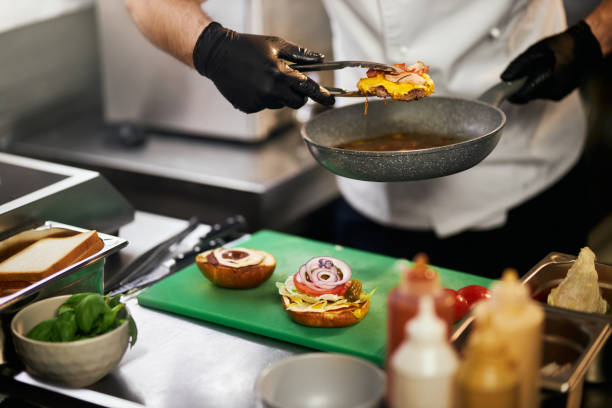 istock Preparation of tasty beef burger with cheese. 1387518341