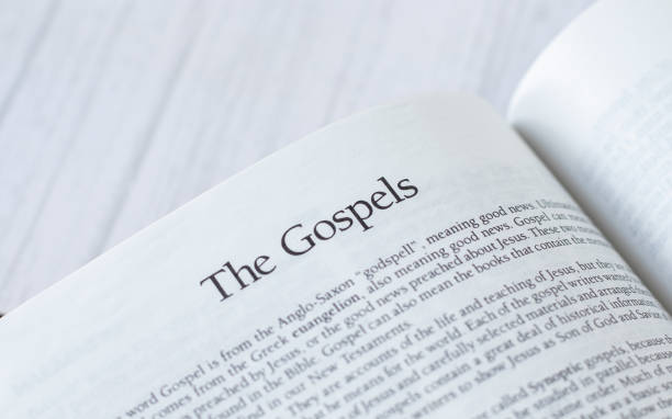 istock Gospels message, open Holy Bible Book isolated on white background 1387519330