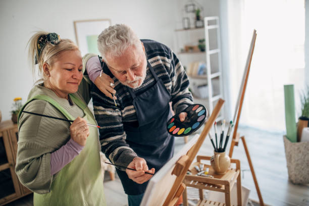 istock senior couple painting on canvas at home 1387520175