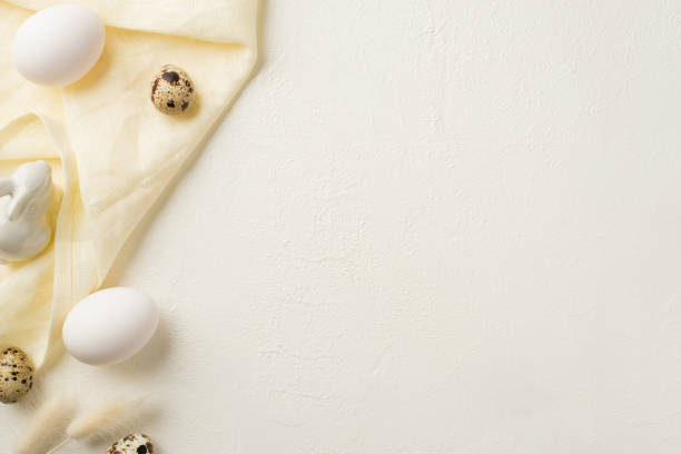 istock Top view photo of easter decorations lagurus flowers ceramic easter bunny eggs and cloth on isolated white background with blank space 1387520700