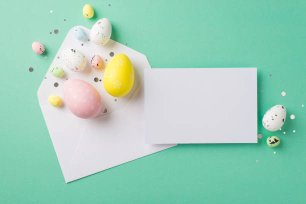 istock Top view photo of easter decorations confetti white open envelope multicolored easter eggs and paper card on isolated turquoise background with blank space 1387520864