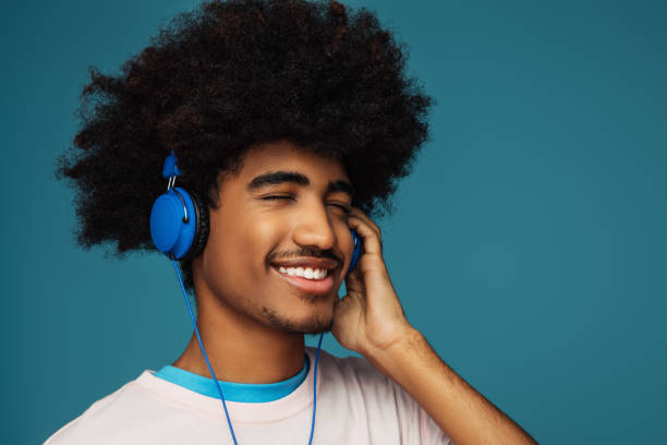 istock African american man with african hairstyle using phone 1387521551