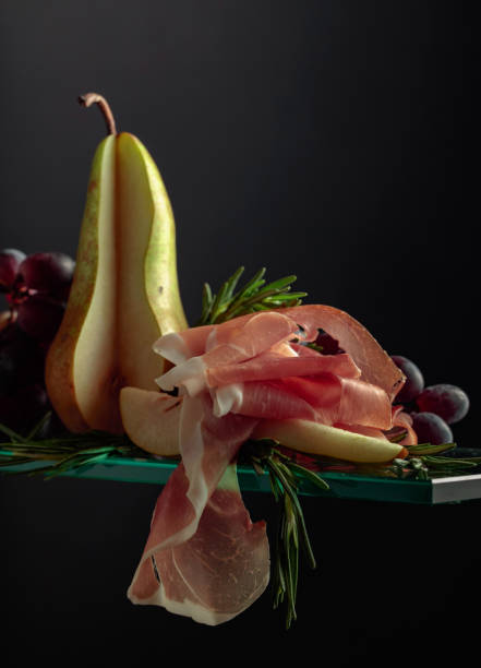 Prosciutto with rosemary, pear, and grapes.