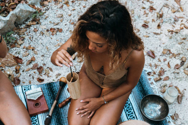 istock One multiracial woman practicing sound healing ceremony in the rainforest 1387523378
