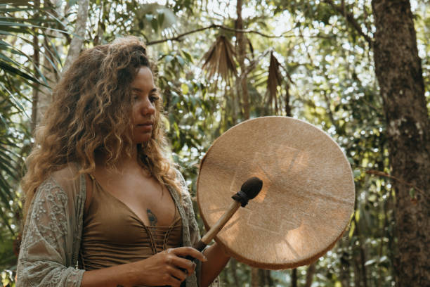 istock One multiracial woman practicing sound healing ceremony in the rainforest 1387524351