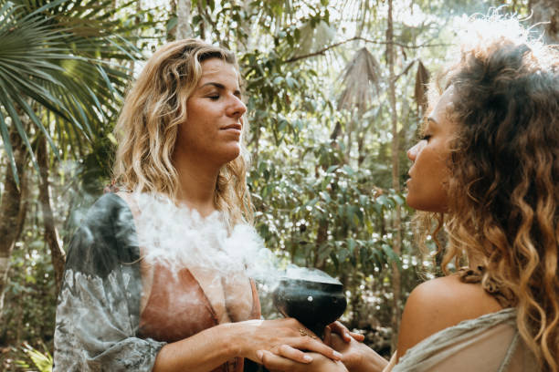 istock Two women doing incense ritual in the jungle 1387524634